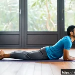 Home 19 디스크 한방치료 효과 - A serene home yoga scene featuring an Indian man in his 30s performing Bhujangasana (cobra pose) on ...